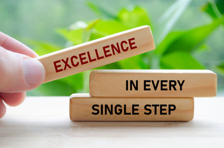 Excellence in every single step text on wooden blocks with blur nature background.の写真素材
