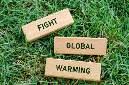Fight Global Warming text on wooden blocks, urging action against climate change and carbon emissions. Climate justice concept.の写真素材