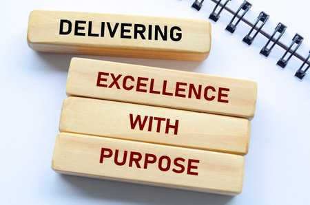 Delivering Excellence With Purpose text on wooden blocks. Quality delivery conceptの写真素材