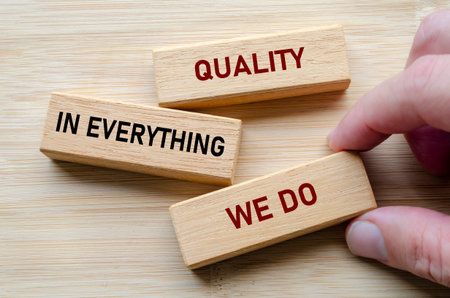 Quality in everything we do message on wooden blocks highlights a commitment to delivering consistent excellenceの写真素材