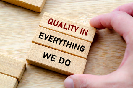 Quality in everything message held with both hands symbolizes attention to detail and pride in craftsmanshipの写真素材