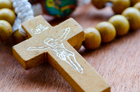Detailed View of Wooden Rosary Cross and Prayer Beads.