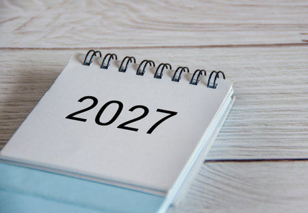 Close up of 2027 calendar on wooden background.の写真素材