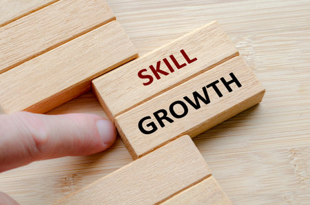SKILL GROWTH text on wooden blocks, Structured plans that promote long-term skill growth and adaptability in a changing environment.の写真素材