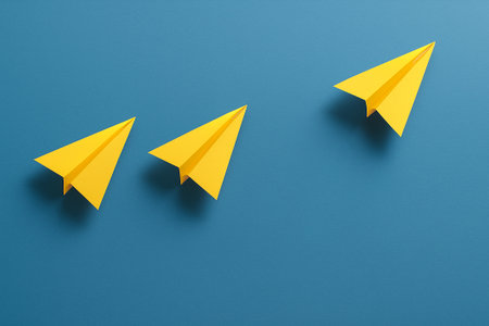 Two yellow airplanes aligned together ahead of a group of white airplanes symbolizing partnership in leadership.の素材