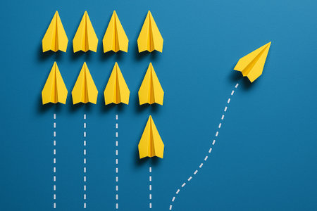 Two yellow airplanes ahead of white ones in a triangle structure for dual leadership strategy.の素材