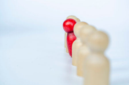 Red wooden doll speaking out which represent courage to speak up.