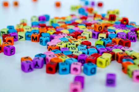 A clustered pile of lively colored alphabet cubes stacked together randomly with clear visibility of different letters representing diversity in communication.の写真素材