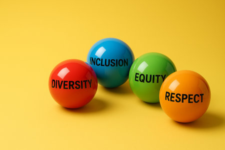 A line of multicolored marbles on yellow background, symbolizing the strength of inclusion and equity through connected diversity.の素材