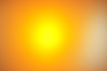 Bright golden yellow gradient with radiant glowing illumination in the center.の素材