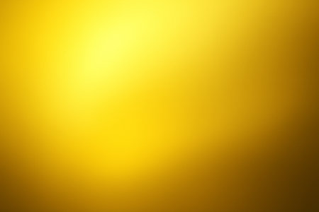 Bright golden yellow abstract gradient background with glowing light effect radiating across.の素材