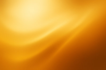 Warm golden gradient with smooth light blending across a glowing surfaceの素材