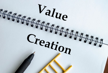 Value Creation, Notebook with ladder illustration representing innovation, growth, and sustainable impactの写真素材