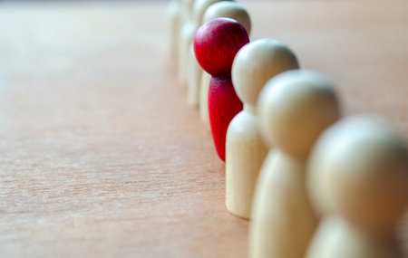 A red figurine stood up representing central focus that may reflect leadership.