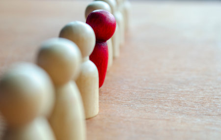 A red figurine stood up representing courage to speak up