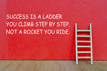 A wooden ladder with text SUCCESS IS A LADDER YOU CLIMB STEP BY STEP, NOT A ROCKET YOU RIDE,...