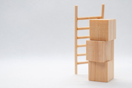 Wooden cubes with wooden ladder with customizable space for text. Copy space conceptの写真素材