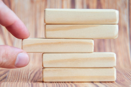 Hand putting wooden block with customizable space for textの写真素材