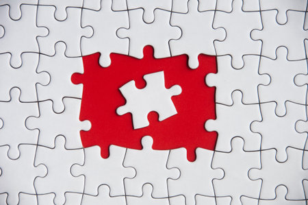 Top view of blank spaces on jigsaw puzzle with on piece placed in the middle. Customizable space for teの写真素材