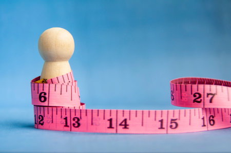 Wooden peg surrounded by pink measuring tape symbolizing health and balance with customizable space...