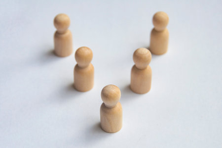 Top view of wooden pegs following a leader.の写真素材