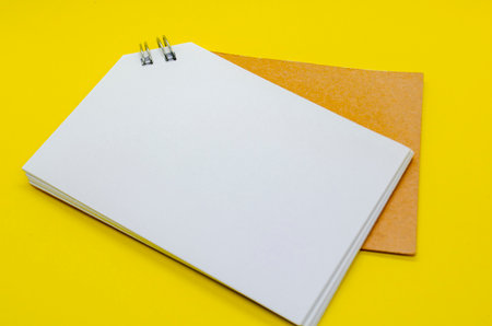 White banner shape notepad with customizable space for text on yellow backgroundの写真素材