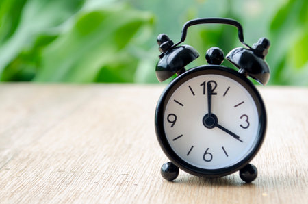 Alarm clock pointing at 4 pm with customizable background space for text or ideas