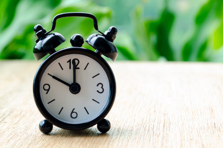 Alarm clock pointing at 10 pm with customizable background space for text or ideasの写真素材