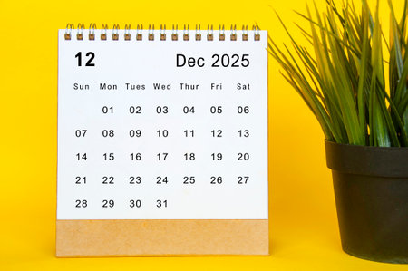 White December 2025 calendar on yellow cover background. Year end concept.の写真素材
