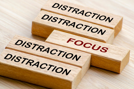 Distraction and Focus text on wooden blocks representing removing distractions to strengthen focus and executionの写真素材