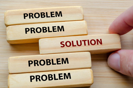 Problem and Solution text on wooden blocks representing shifting from constant problems toward a clear solution mindsetの写真素材