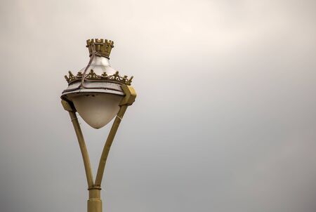 Beautiful vintage street lamp of the colonial town of Iza, photographed against the overcasted sky, in the Andean mountains of central Colombia.の写真素材