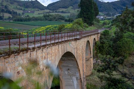 View of the old Bertucci train bridge built in 1931 at the highlands of the Andean mountains of central Colombia.の写真素材