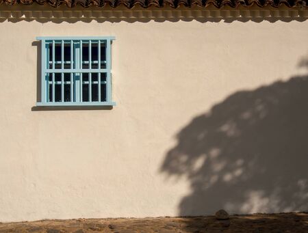View of an old wooden window at sunset in the streets of the colonial town of Villa de Leyva, in the Andean mountains of central Colombia.の写真素材