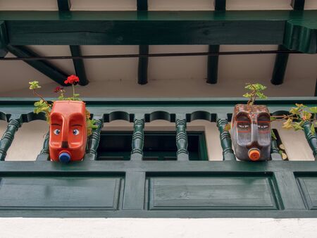 Decorative plastic pots made from plastic bottles in a colonial balcony of a house at the colonial Town of Villa de Leyva, in the Andean mountains of central Colombia.の写真素材