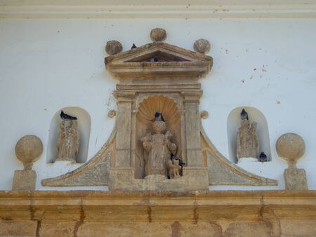 Detail of the external ornaments of the Our lady of Mount Carmel church with some doves, at the colonial town of Villa de Leyva, in the Andean mountains of central Colombia.の写真素材