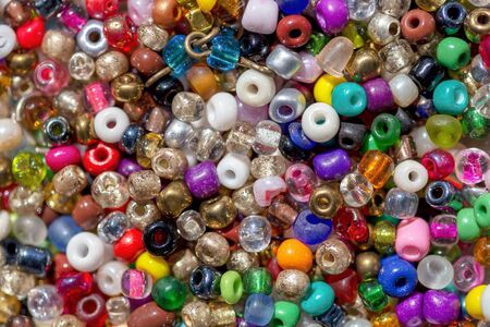 Macro photography of a heap of assorted colorful plastic beadsの写真素材