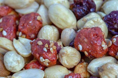 Macro photography of a heap of mixed nuts and cranberries.の写真素材