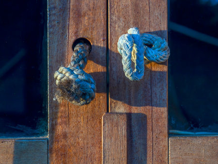 Close-up photography of pieces of rope used as door handles in a house near the colonial town of...