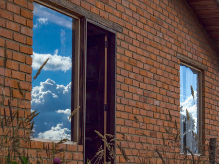 The sky reflecting on two windows of a country house near the town of Villa de Leyva in the central Andean mountains of Colombia.の写真素材