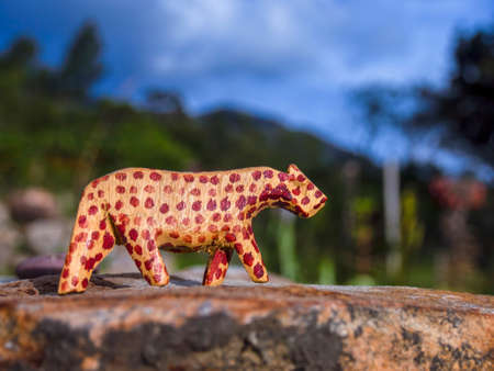 Handcrafted wooden animal figurines photographed in natural environments at sunset in a farm house near the colonial town of Villa de Leyva, in Colombia.の写真素材