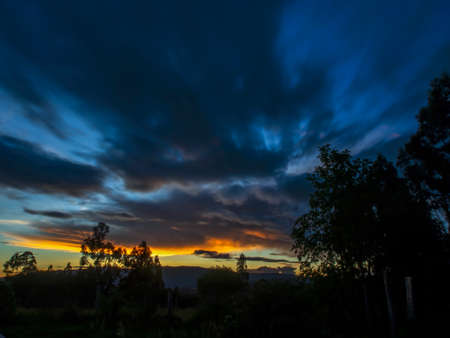 The colors of the afterglow on different kinds of clouds over the valley near the town of Villa de Leyva in central Colombia.の写真素材