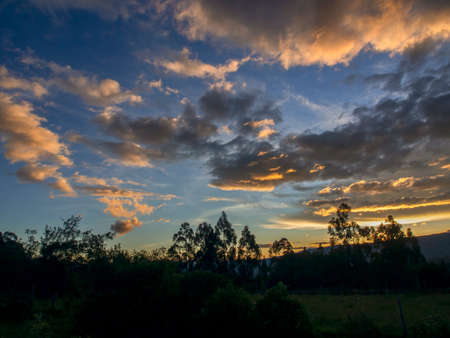 The colors of the afterglow on different kinds of clouds over the valley near the town of Villa de Leyva in central Colombia.の写真素材