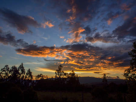 The colors of the afterglow on different kinds of clouds over the valley near the town of Villa de Leyva in central Colombia.の写真素材