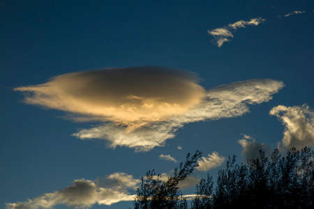 Multiple exposure composite of a zeppelin shaped cloud floating over the plateau near the colonial town of Villa de Leyva in central Colombia.の写真素材