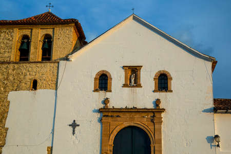 The facade of the church of Our Lady of the Rosary, the main catholic church of the colonial town of Villa de Leyva in the eastern Andes range of central Colombia.の写真素材