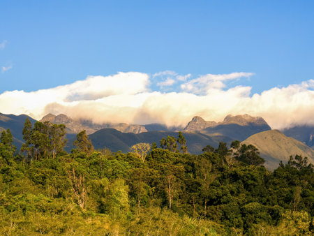A dense cloud floats over the mountains of the Iguaque region at sunset in the eastern Andes range of central Colombiaの写真素材