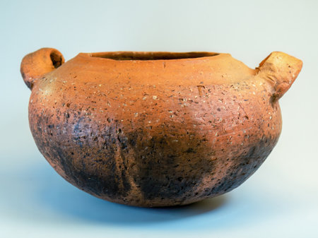 Studio shot of an old used traditional clay cooking pot on a neutral backgroundの写真素材