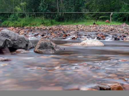 Long-exposure photography of the stream and rocks of Del Valle river, near the town of La Palma in the central Andean mountains of Colombia.の写真素材