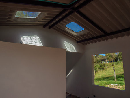 Interior of a brand new workshop with the sunlight entering through a couple of skylights and the view of the window.の写真素材